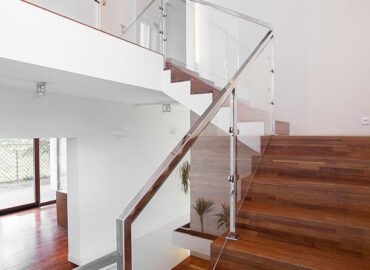 Image of solid wooden stairs with elegant glass balustrade